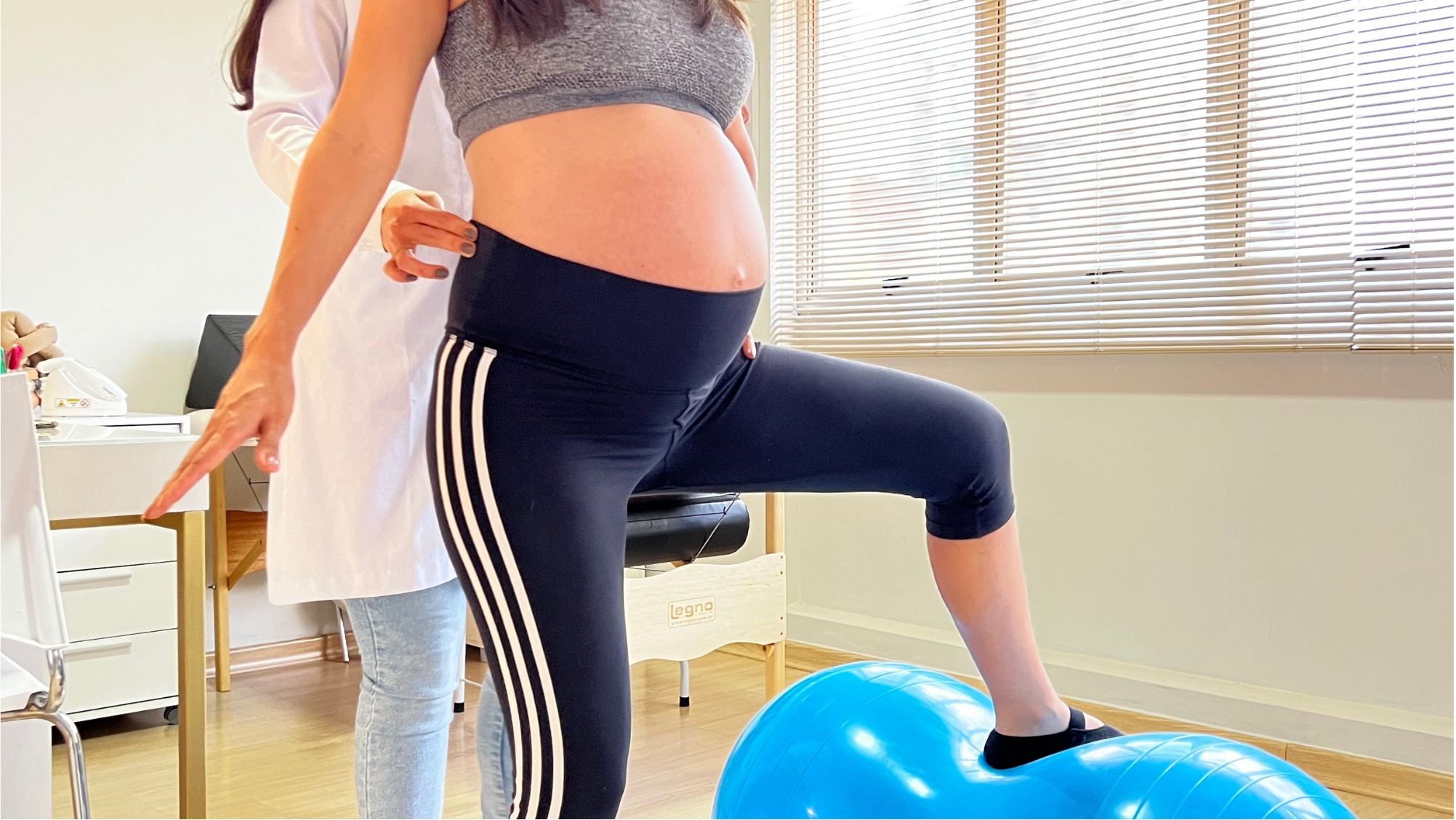 Exercise with blue ball and pregnant patient standing